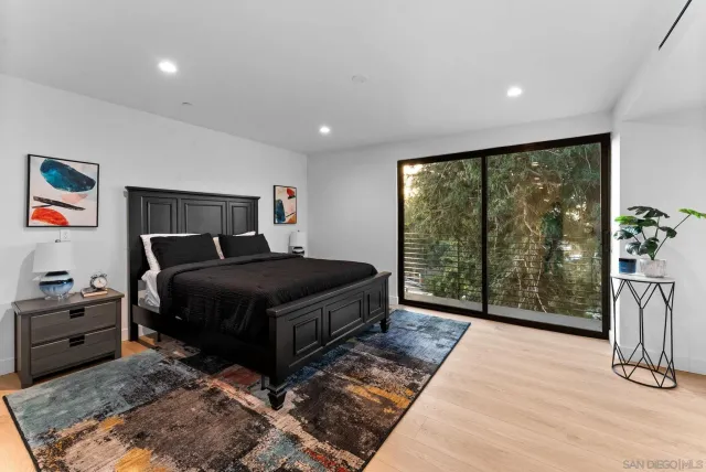 a bedroom with a bed and glass window