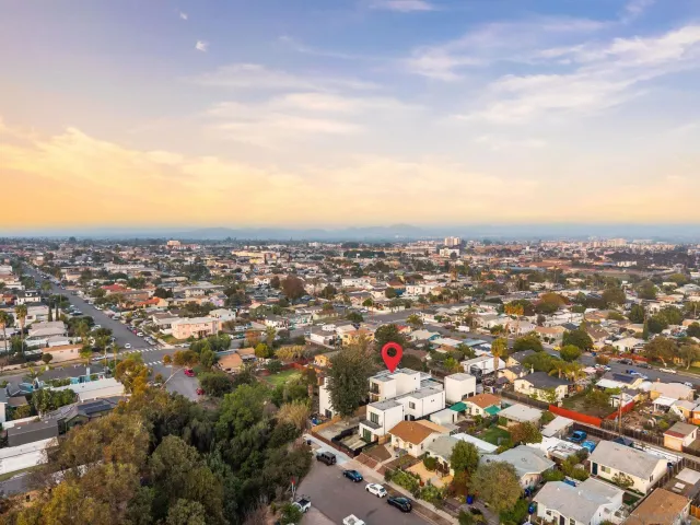an aerial view of residential houses with city view