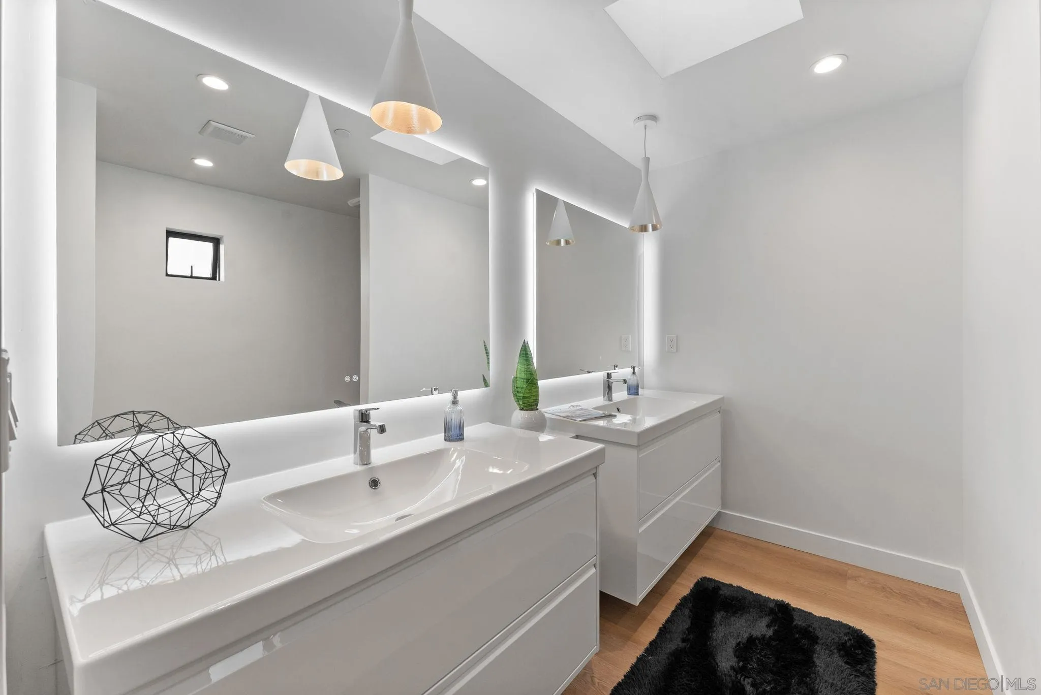 3653 Wilson Avenue San Diego, CA 92104 - Photo 29 of 60 a en suite bathroom with a granite countertop sink and a mirror