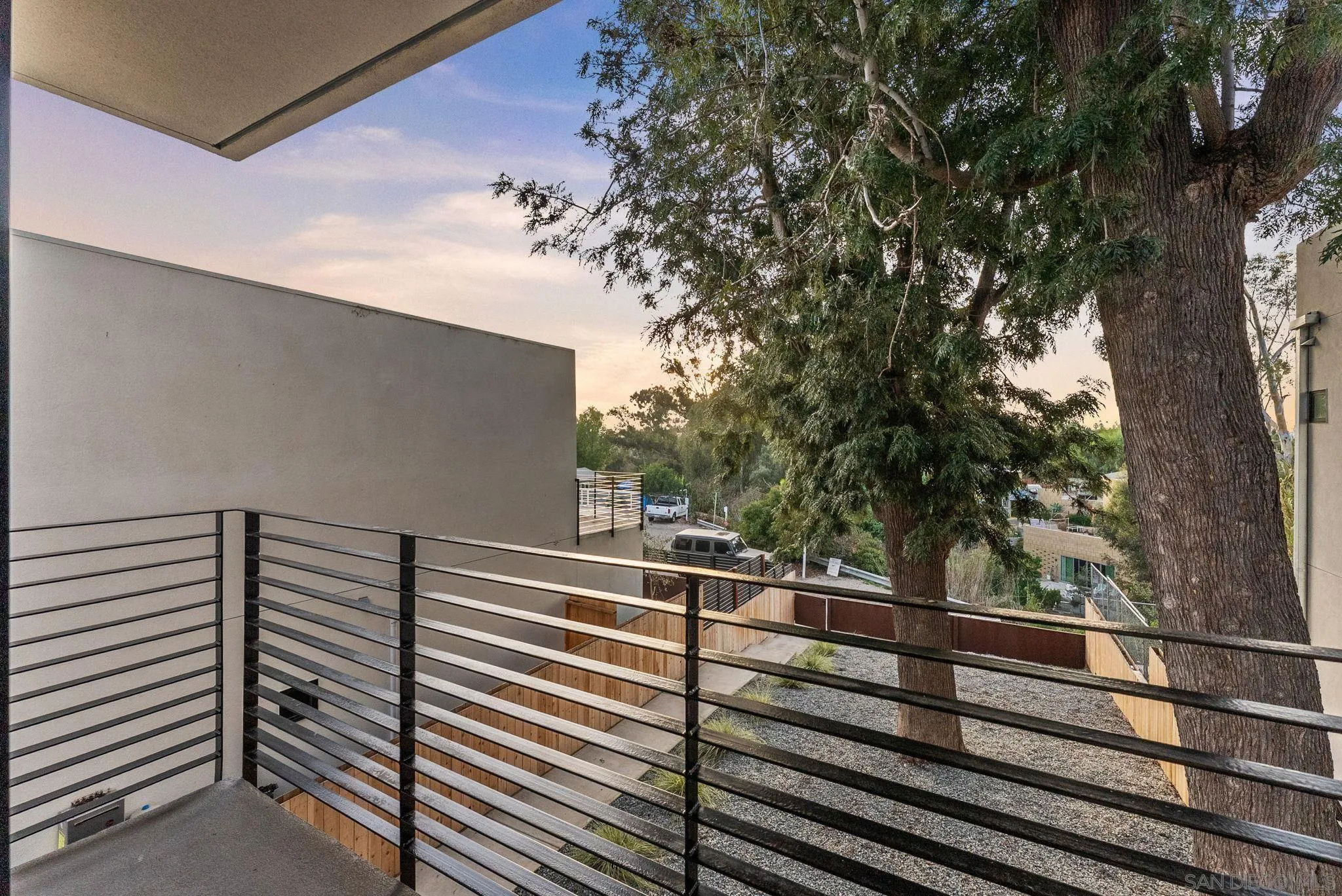3653 Wilson Avenue San Diego, CA 92104 - Photo 50 of 60 a view of a balcony with wooden floor and fence and a bench