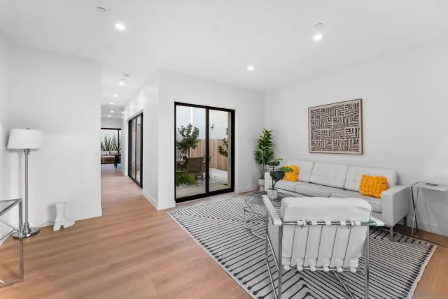 a view of a hallway with furniture and a livingroom