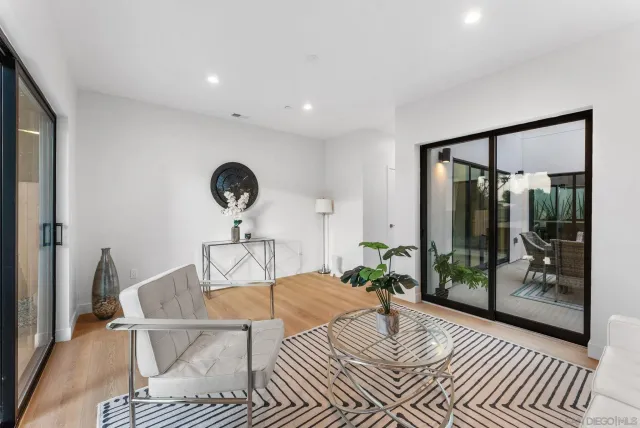 a living room with furniture a glass door and a table