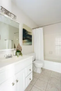 a bathroom with a sink a toilet and mirror