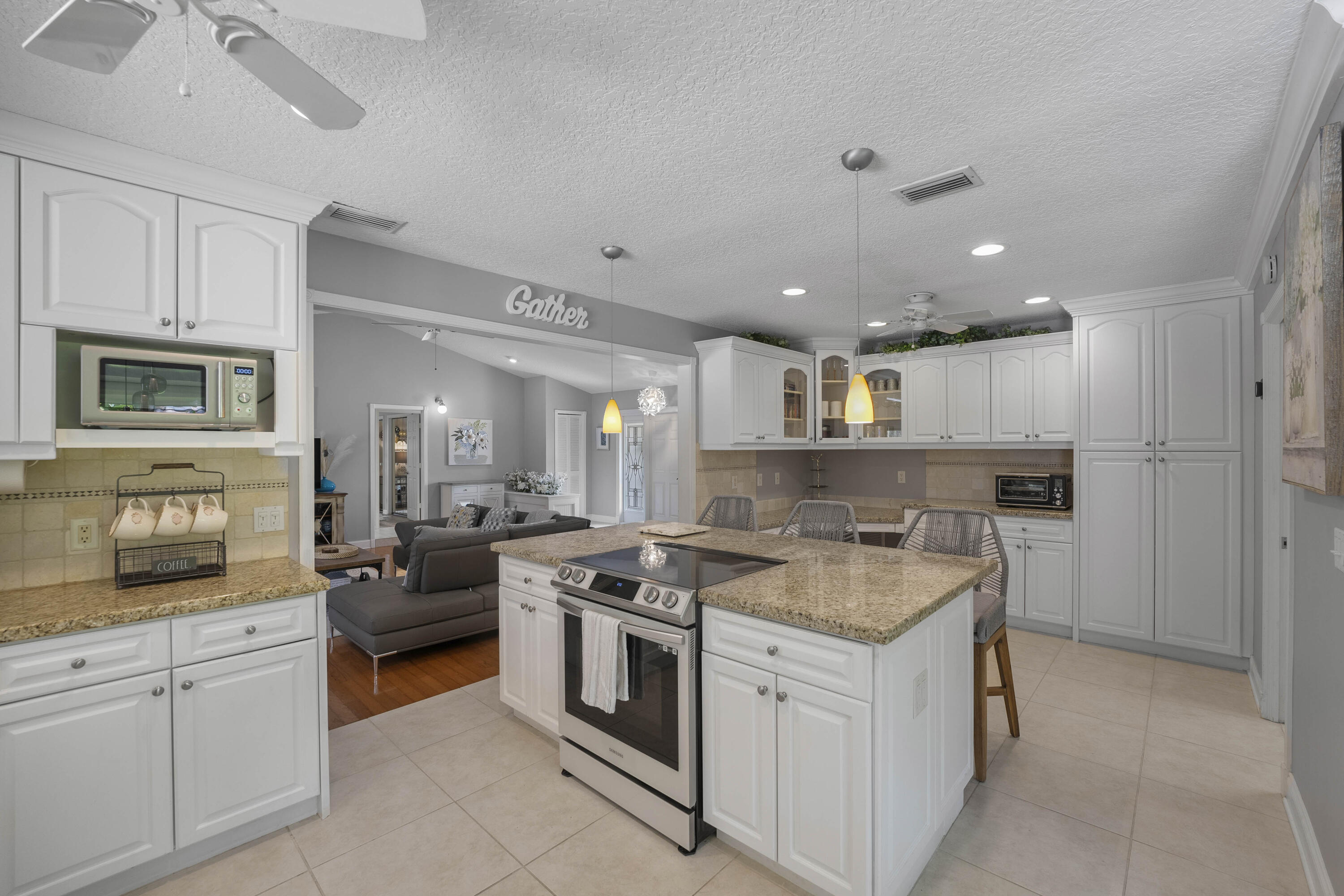 196 Scarborough Terrace Wellington, FL 33414 - Photo 13 of 33 a kitchen with a stove and a refrigerator