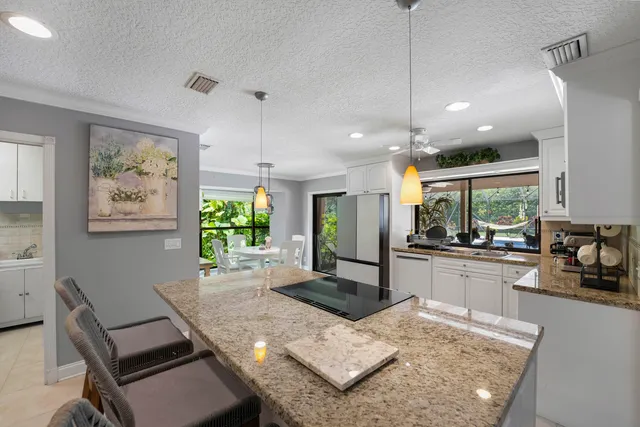 a kitchen with sink and view of living room