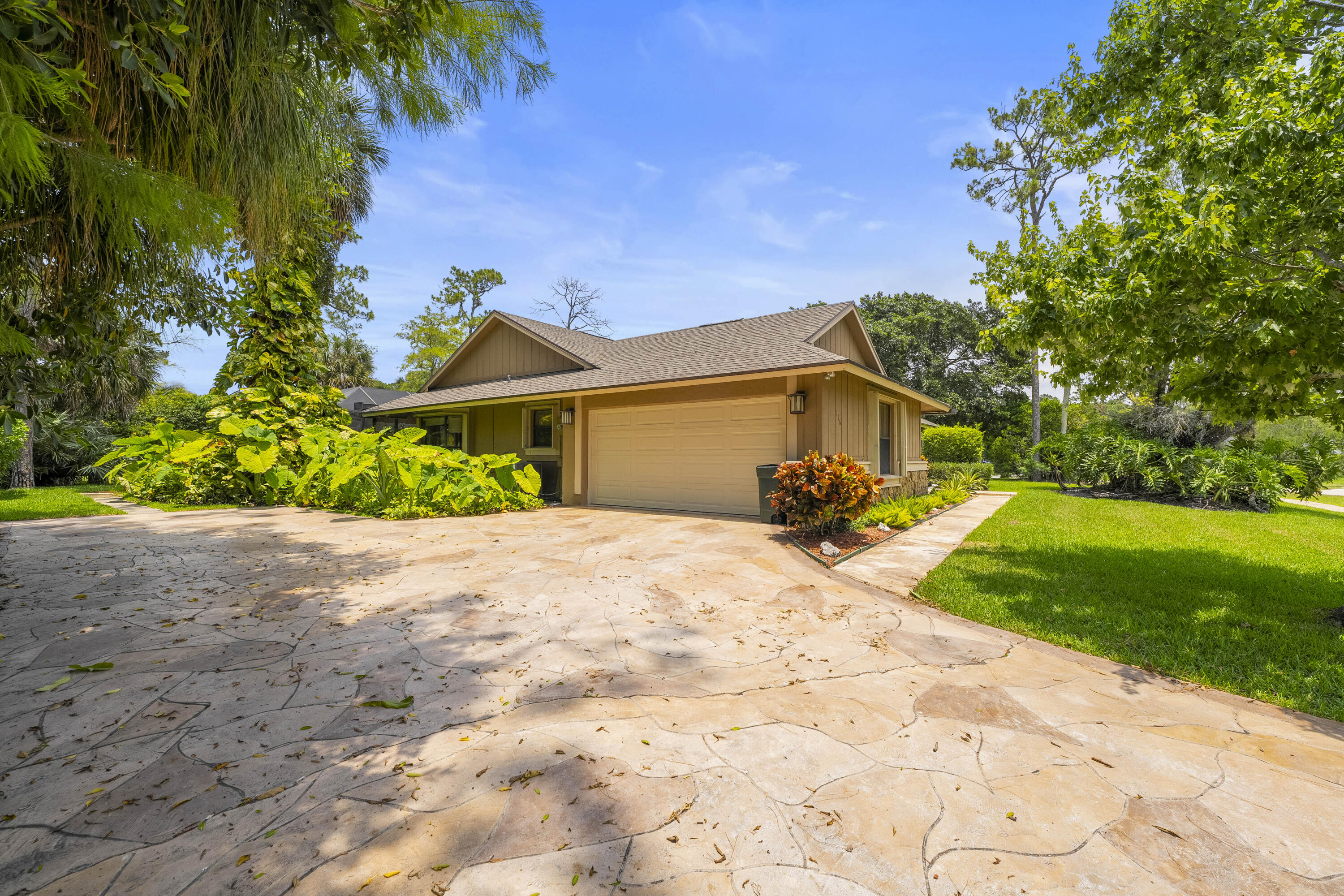 196 Scarborough Terrace Wellington, FL 33414 - Photo 2 of 33 a front view of a house with a garden and yard