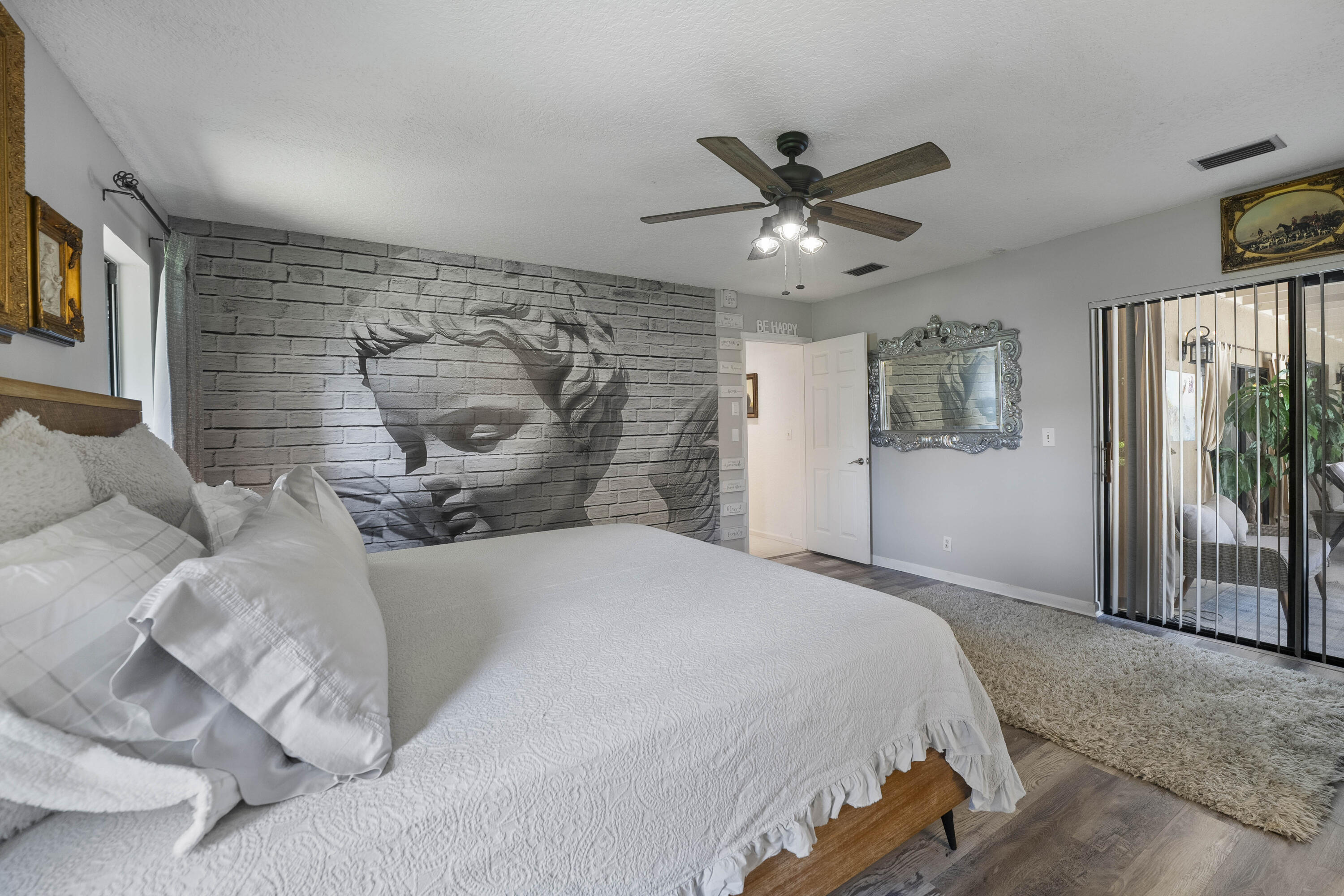 196 Scarborough Terrace Wellington, FL 33414 - Photo 24 of 33 a bedroom with a bed and a chandelier