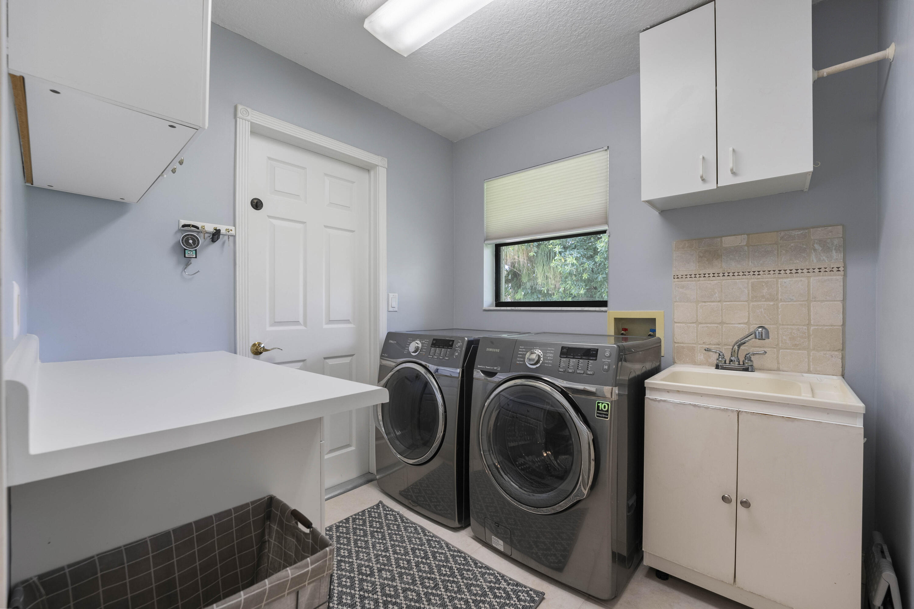 196 Scarborough Terrace Wellington, FL 33414 - Photo 28 of 33 a utility room with sink dryer and washer