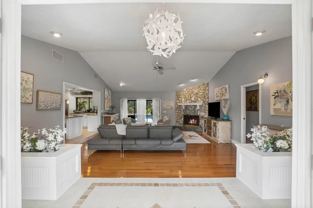 a living room with fireplace furniture and a chandelier