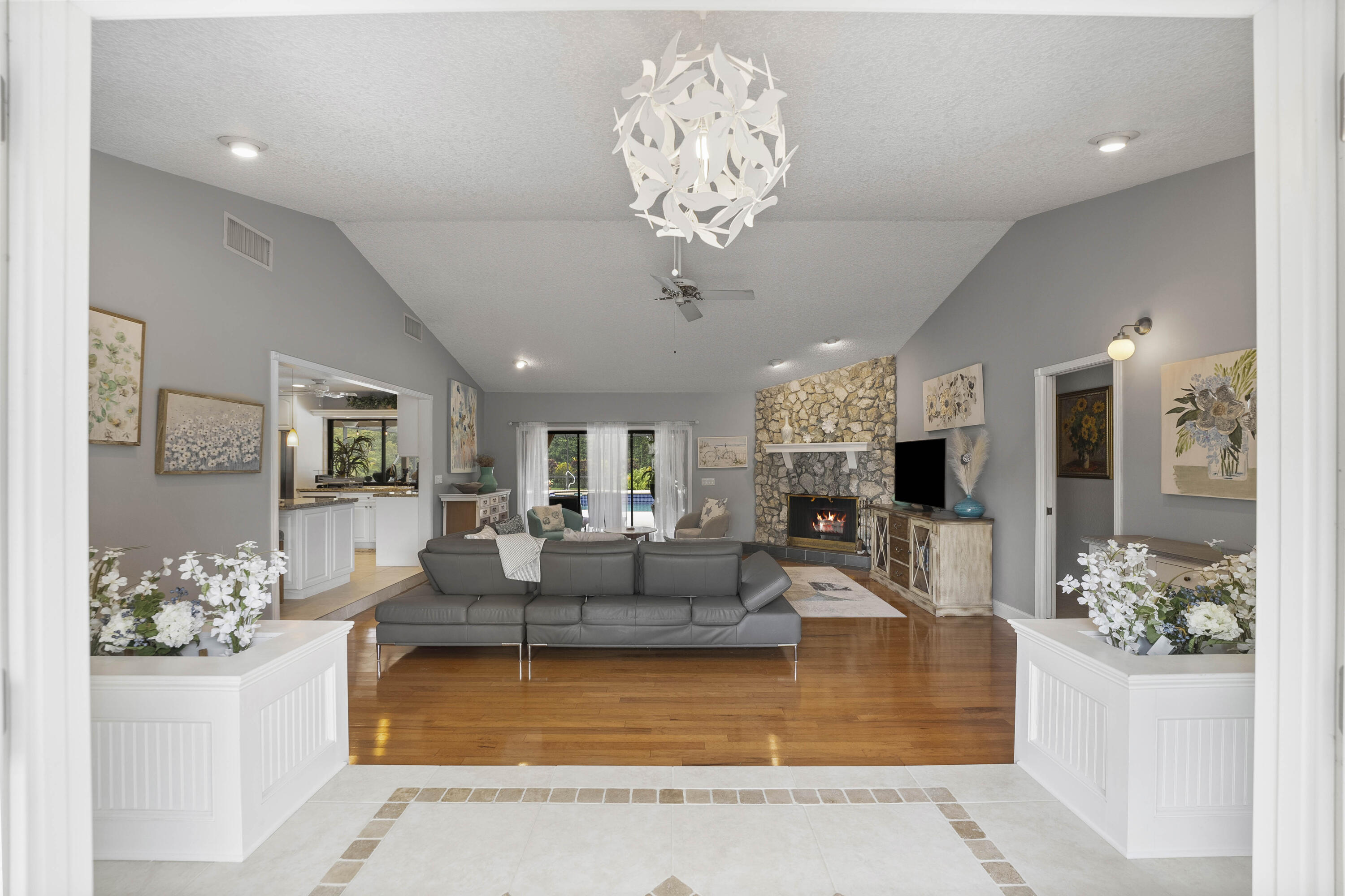 196 Scarborough Terrace Wellington, FL 33414 - Photo 5 of 33 a living room with fireplace furniture and a chandelier