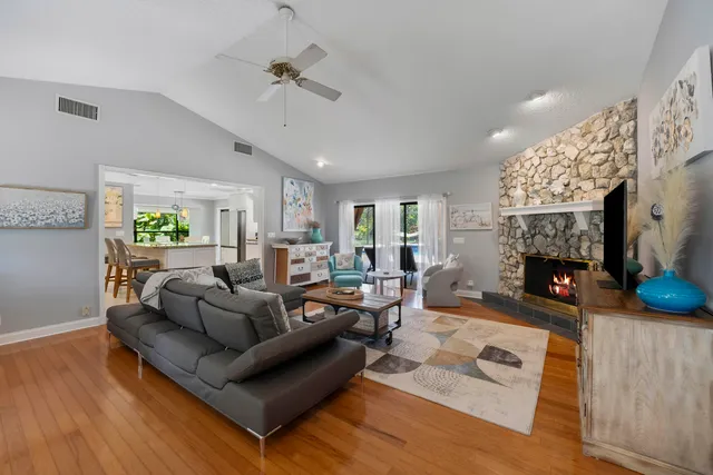 a living room with furniture a fireplace and a flat screen tv