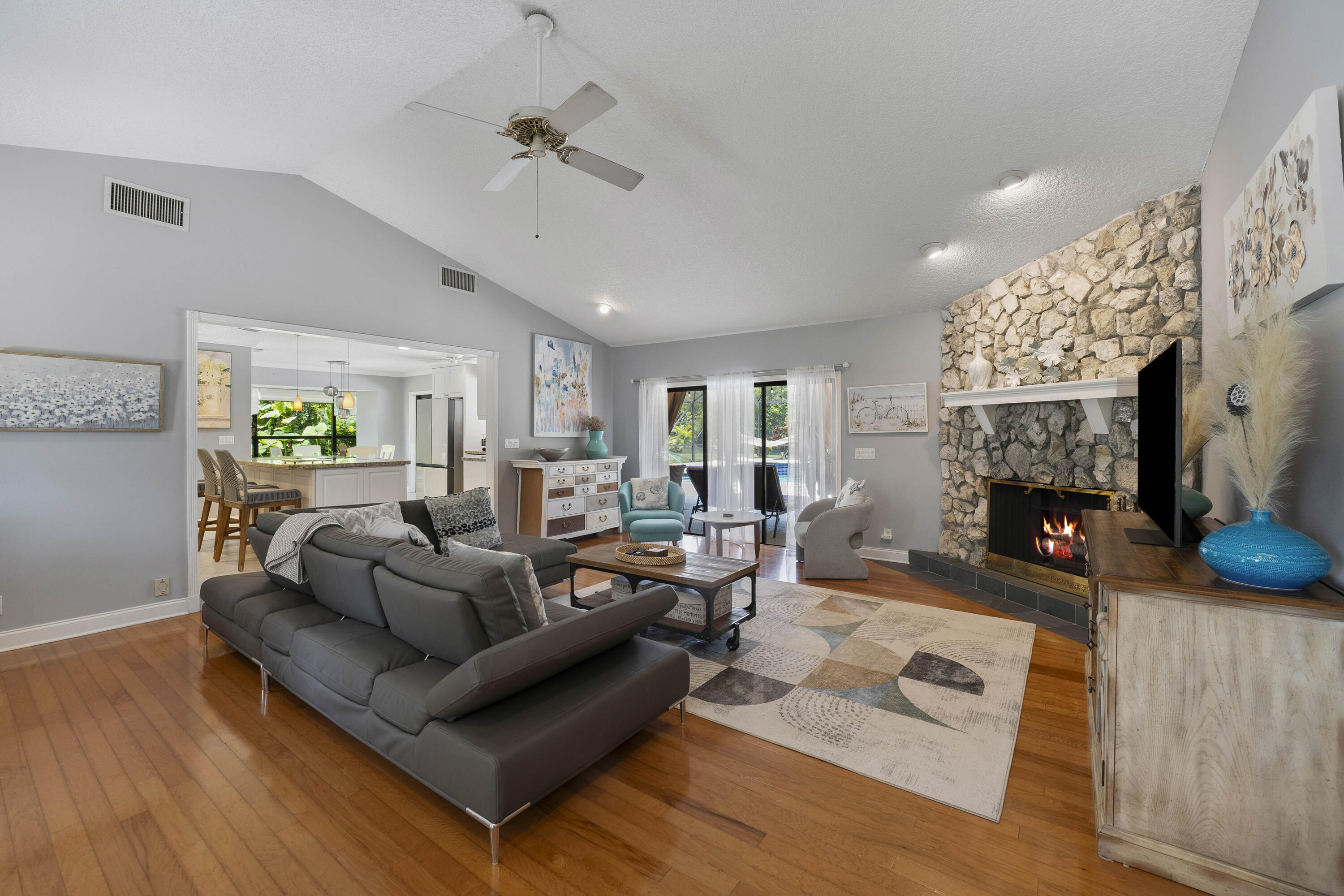 196 Scarborough Terrace Wellington, FL 33414 - Photo 6 of 33 a living room with furniture a fireplace and a flat screen tv