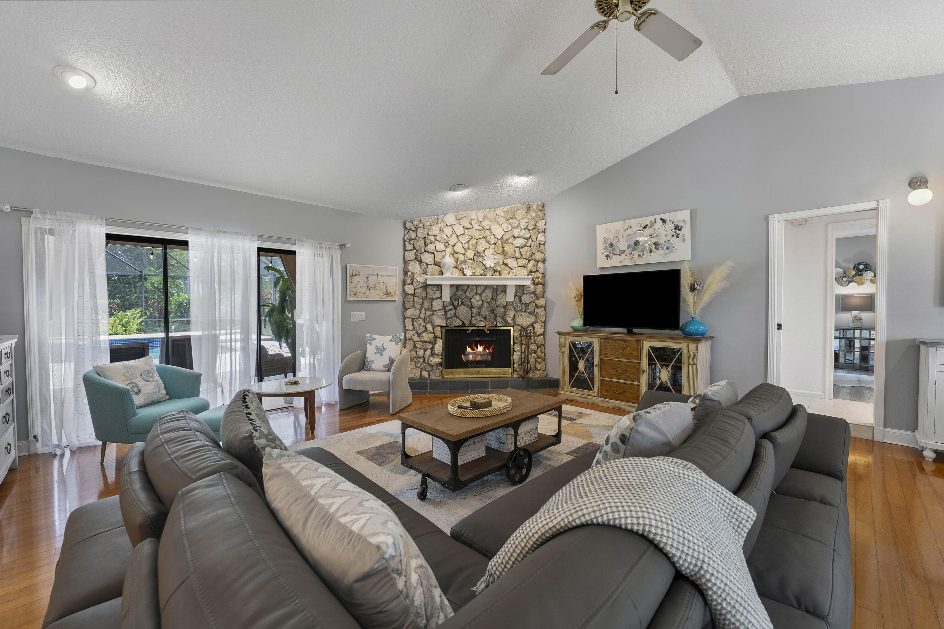 196 Scarborough Terrace Wellington, FL 33414 - Photo 7 of 33 a living room with furniture a flat screen tv and a fireplace