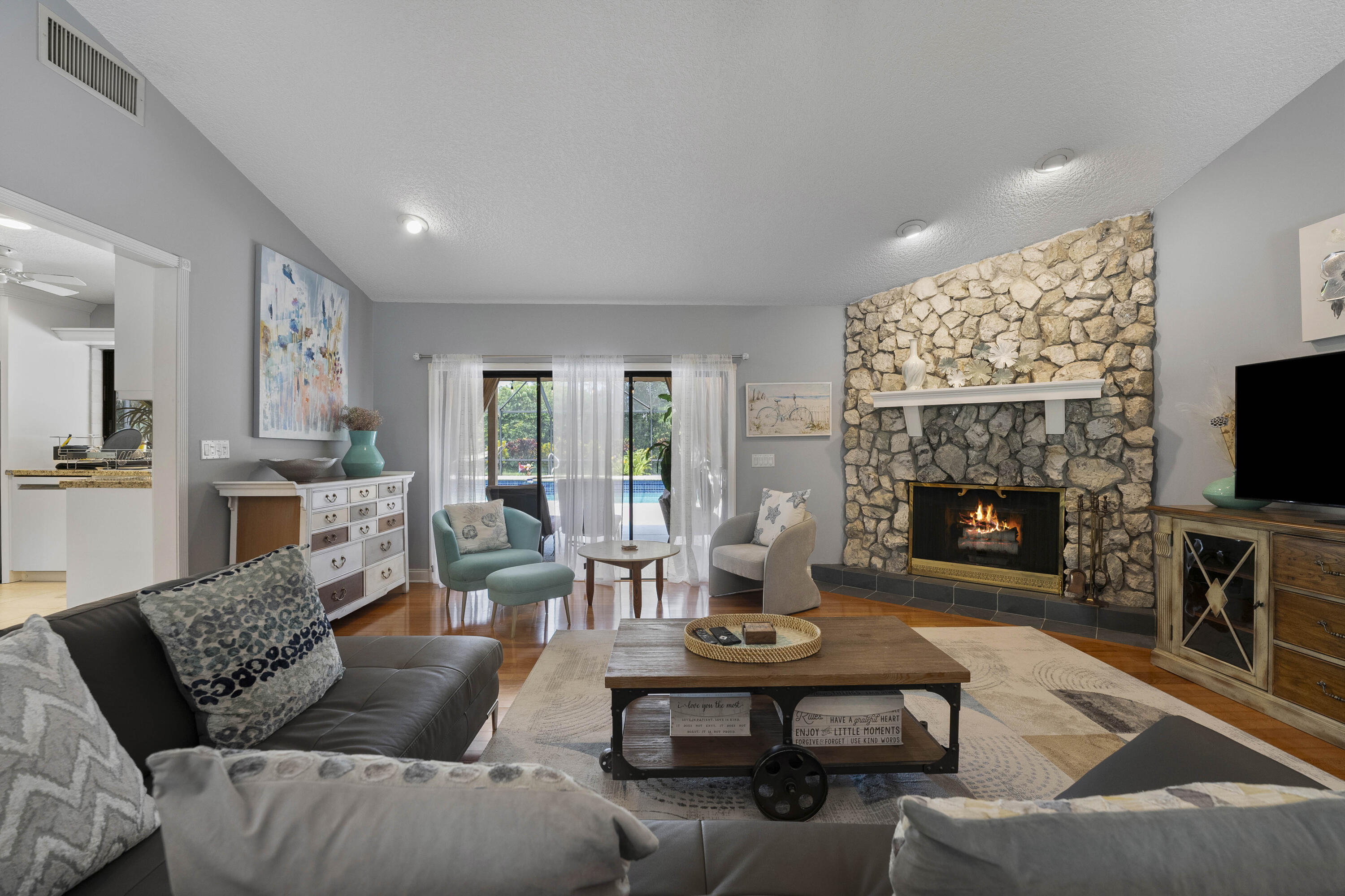 196 Scarborough Terrace Wellington, FL 33414 - Photo 8 of 33 a living room with furniture a flat screen tv and a fireplace