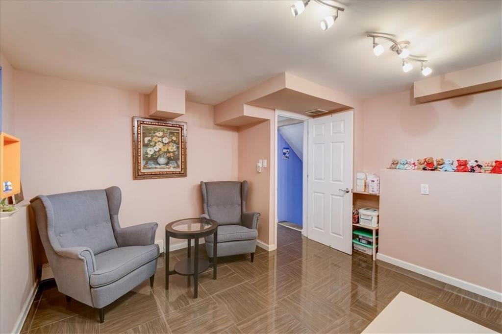 829 Bruce Drive East Meadow, NY 11554 - Photo 11 of 27 a living room with furniture and a table
