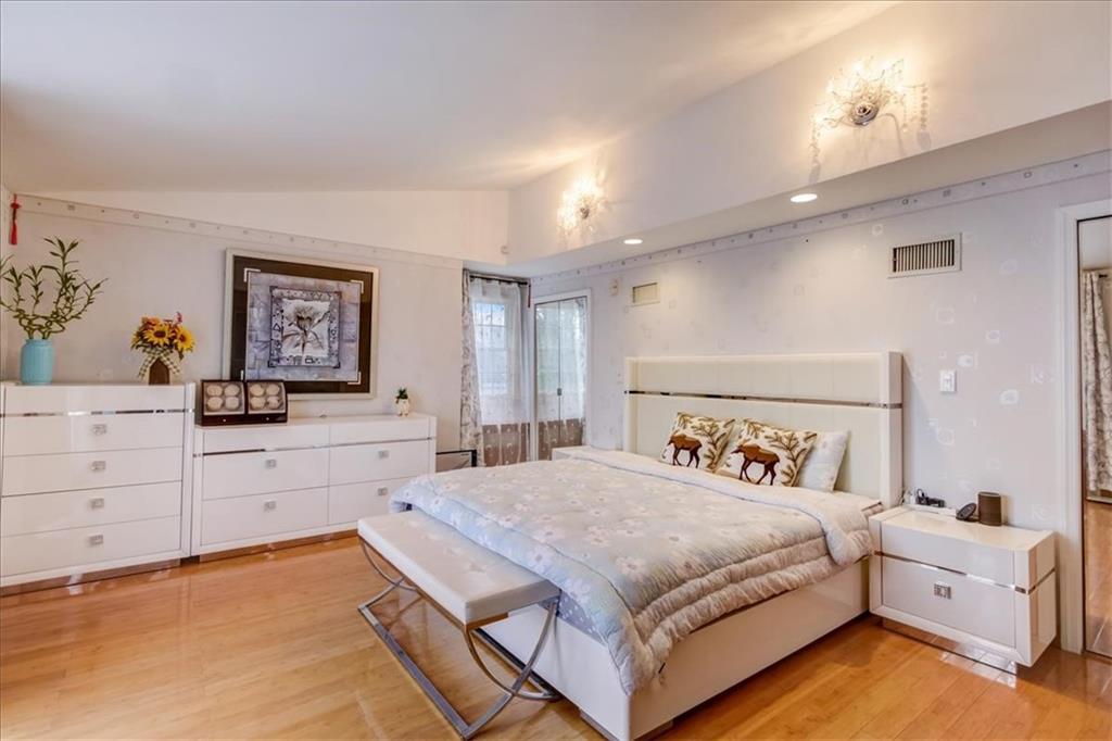 829 Bruce Drive East Meadow, NY 11554 - Photo 16 of 27 a spacious bedroom with a bed and a dresser