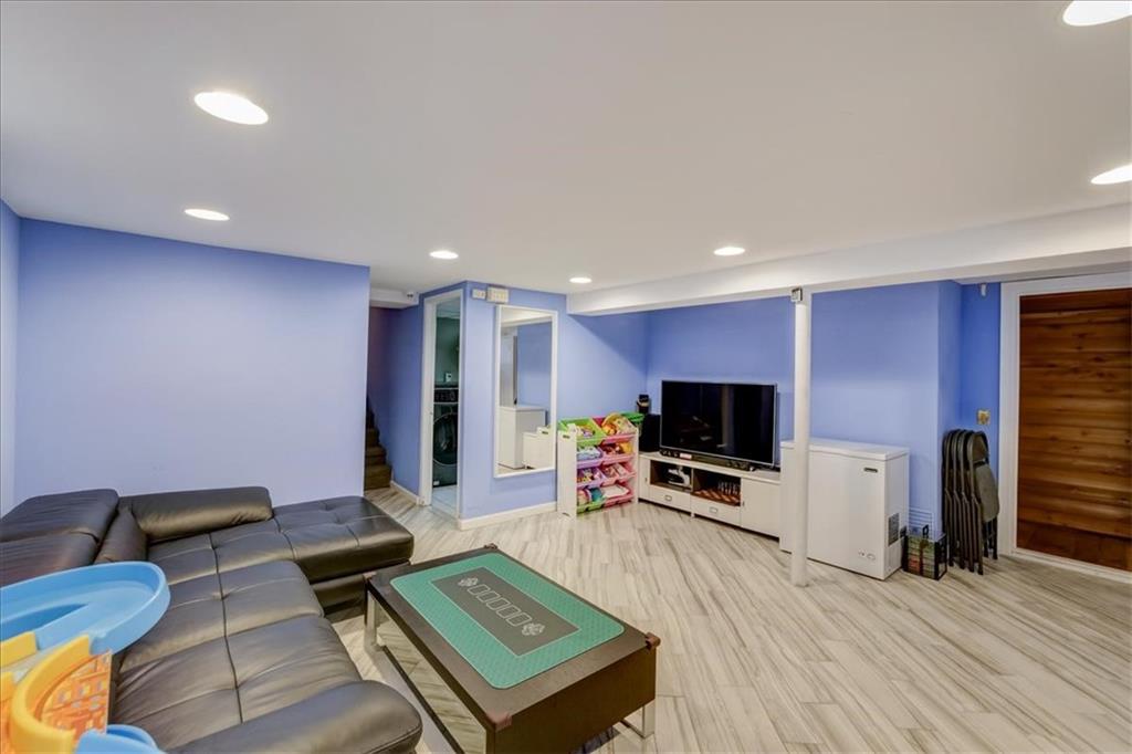 829 Bruce Drive East Meadow, NY 11554 - Photo 20 of 27 a living room with furniture a flat screen tv and kitchen view