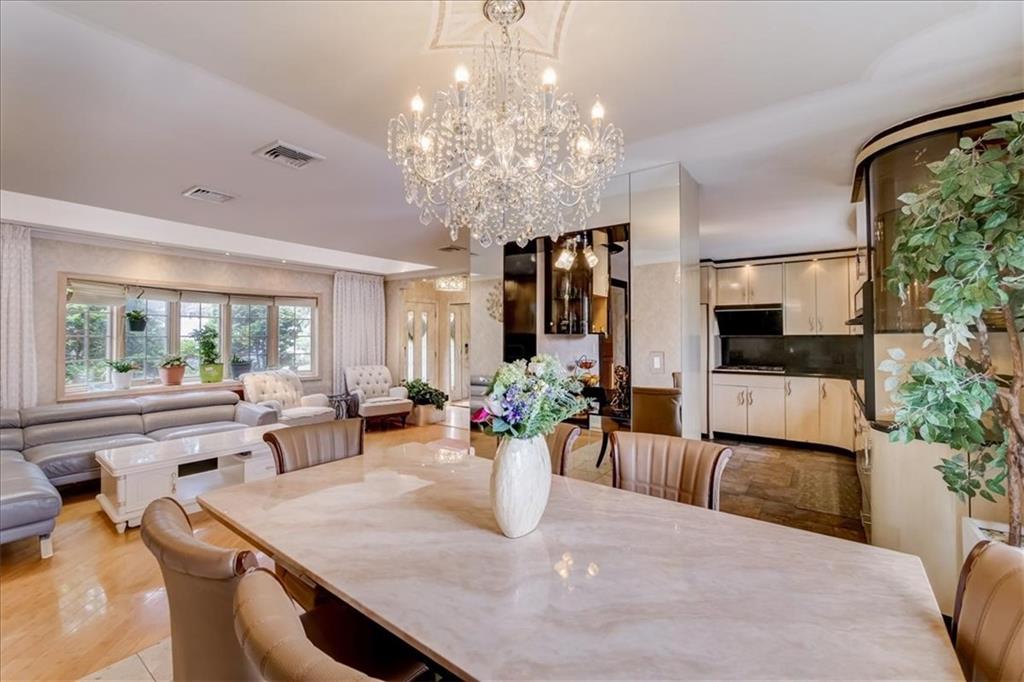 829 Bruce Drive East Meadow, NY 11554 - Photo 5 of 27 a view of a dining room with furniture a chandelier and large windows