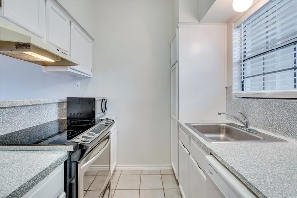 a kitchen with a stove and a microwave