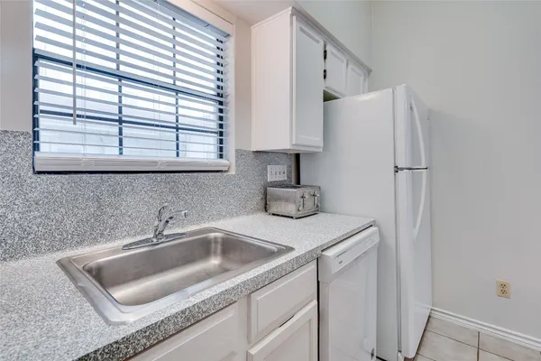a bathroom with a sink tub shower and a mirror