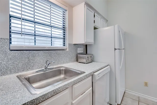 a bathroom with a sink tub shower and a mirror