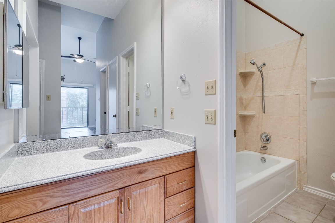 1908 San Antonio Street, Unit 306 Austin, TX 78705 - Photo 18 of 28 a bathroom with a sink tub shower and a mirror