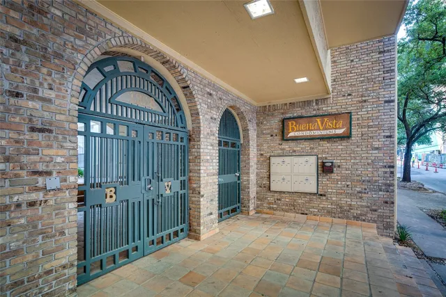 a view of a door with brick walls