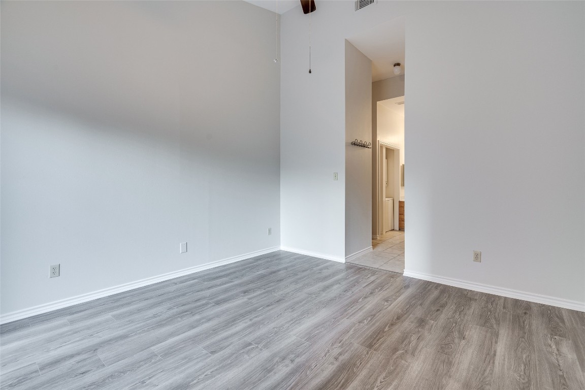 1908 San Antonio Street, Unit 306 Austin, TX 78705 - Photo 22 of 28 a view of an empty room with wooden floor and a window
