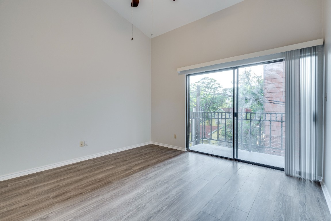 1908 San Antonio Street, Unit 306 Austin, TX 78705 - Photo 23 of 28 a view of an empty room with wooden floor and a window