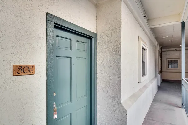 a view of a hallway with windows and entryway