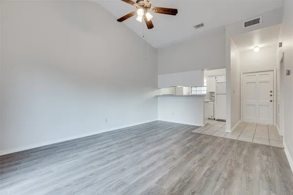 a white refrigerator freezer and a wooden floor