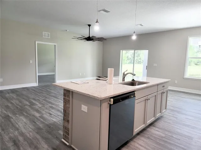 a view of entryway and hall with a ceiling fan