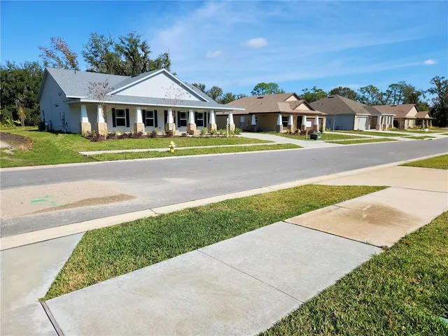 a front view of a house with a garden and plants