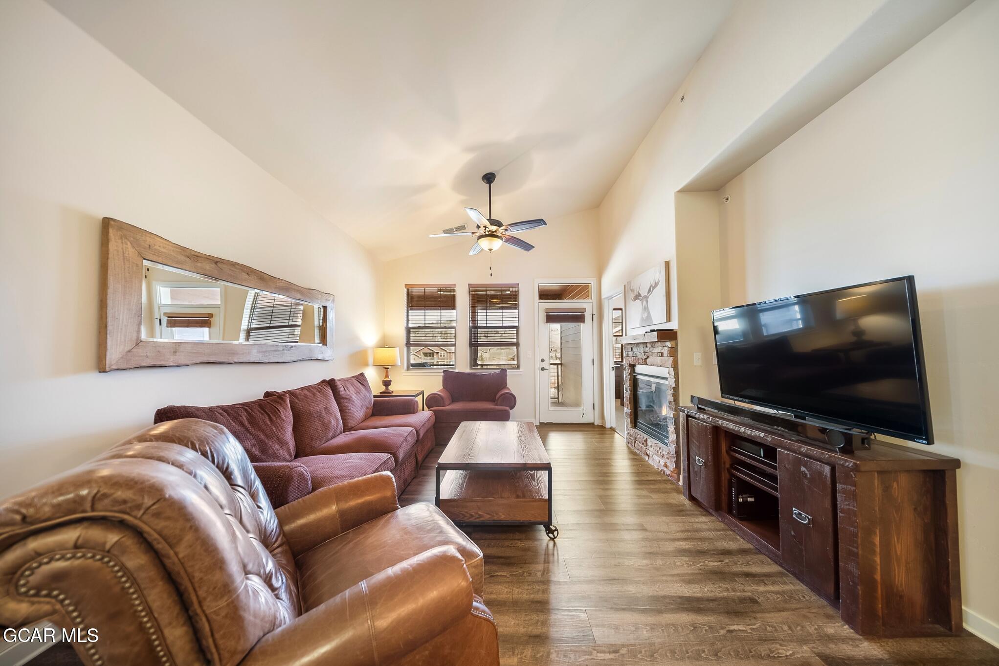 162 Village Road, Unit G303 Granby, CO 80446 - Photo 7 of 37 a living room with furniture and a flat screen tv