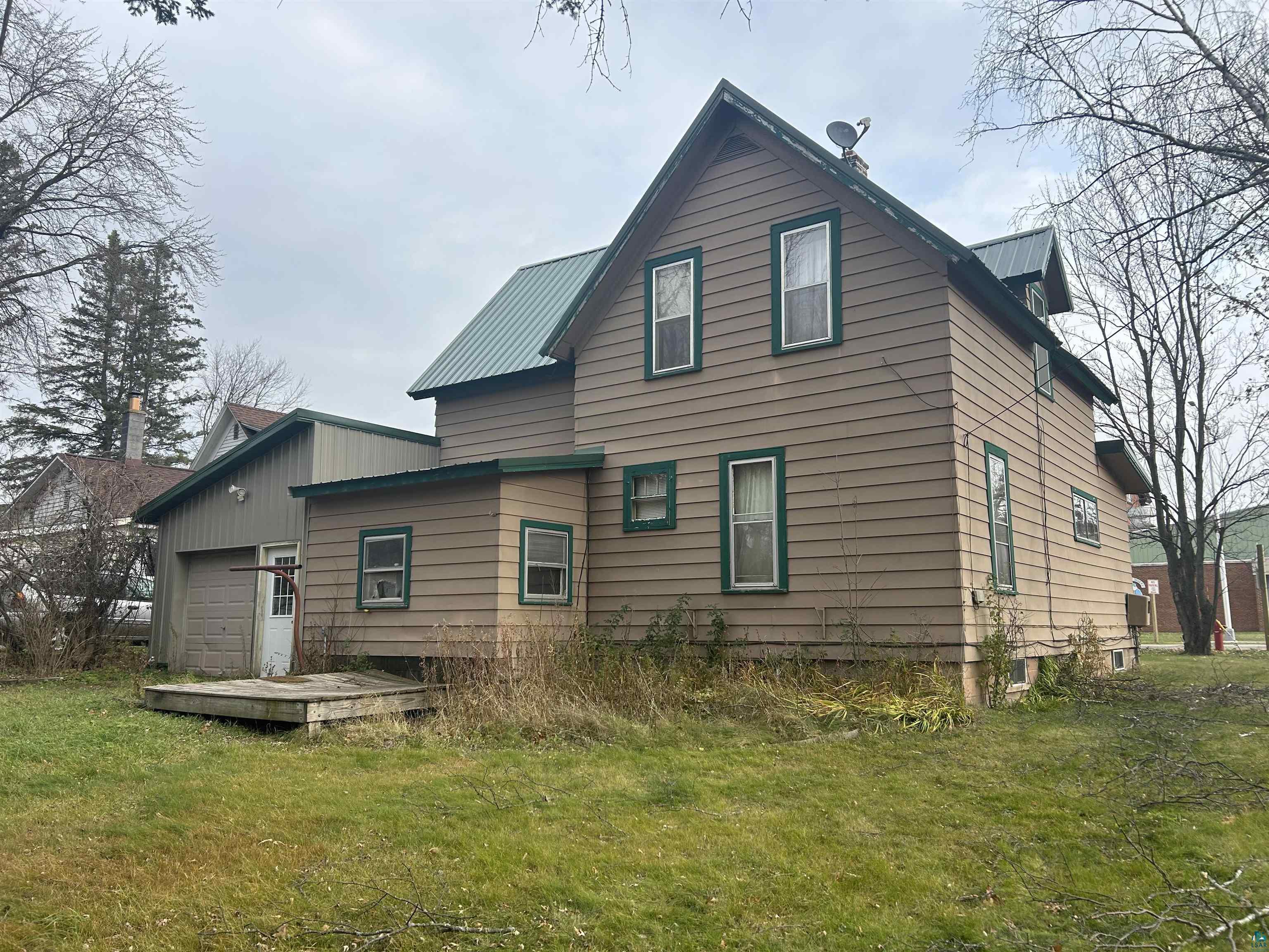 421 South Main Street Mellen, WI 54546 - Photo 3 of 8 Back of property featuring a garage and a yard