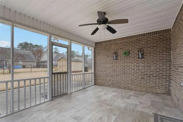 a view of a livingroom with a ceiling fan and window