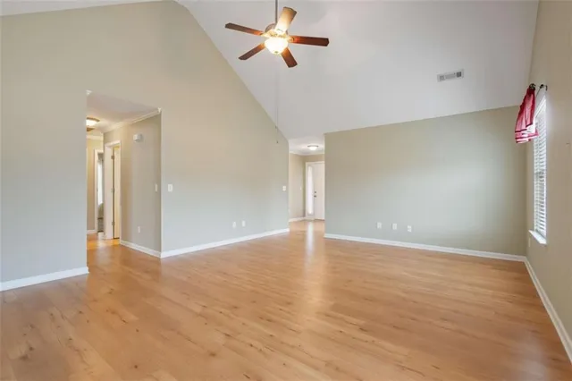 wooden floor in an empty room with a window
