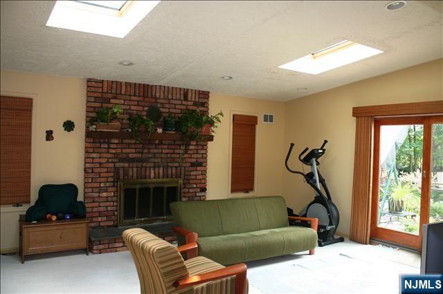 82 Heatherhill Road Cresskill, NJ 07626 - Photo 8 of 9 a living room with furniture and a fireplace