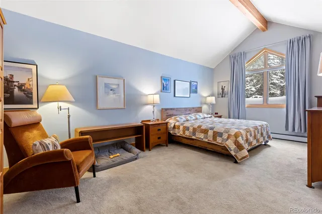 a bedroom with a bed chair and a window