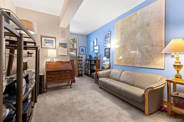 a living room with furniture a lamp and a window