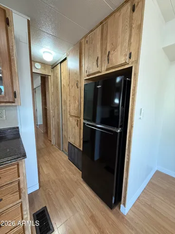 a kitchen with a refrigerator and a stove