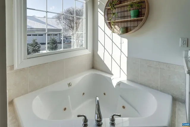 a spacious en suite bathroom with double sink and a large mirror