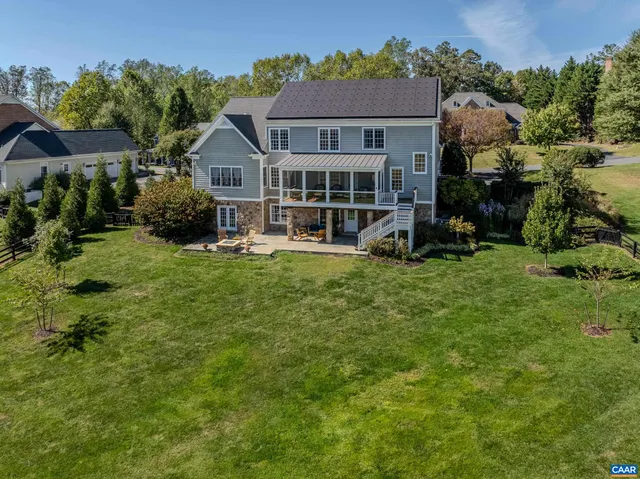 a view of a house with backyard porch and sitting area