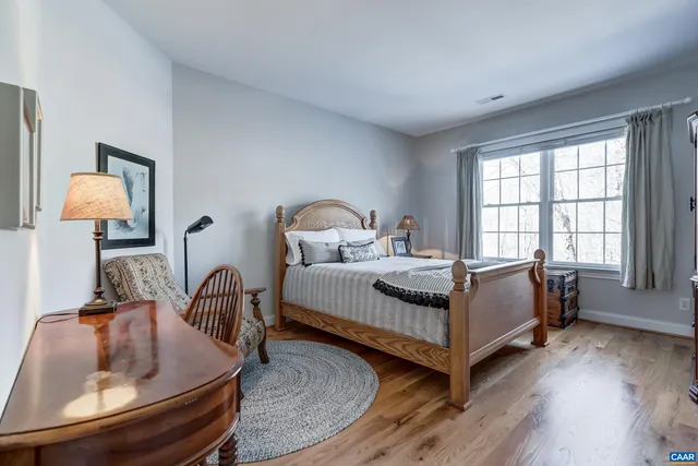 a bathroom with a double vanity sink toilet and a mirror