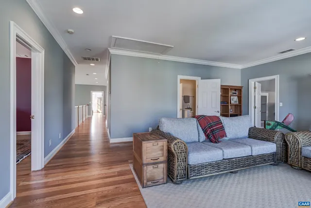a living room with furniture a piano and a window