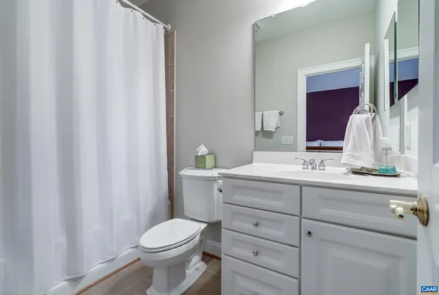 a living room with furniture a rug and a table