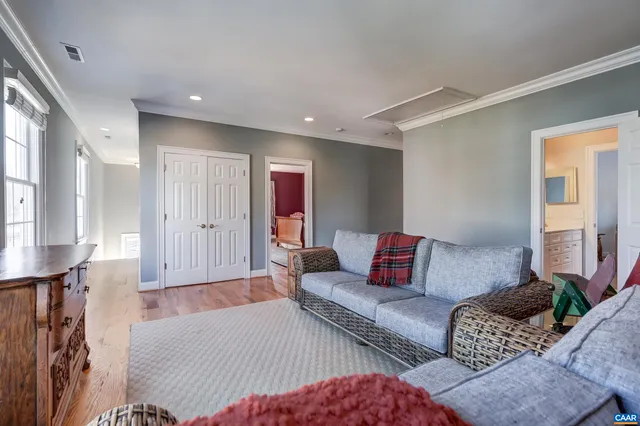 a living room with furniture a piano and a fireplace