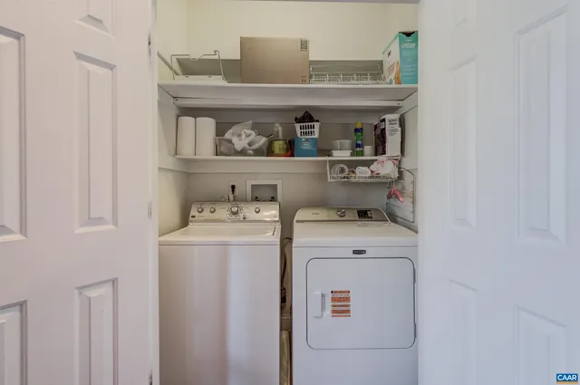 a living room with furniture a window and a clock