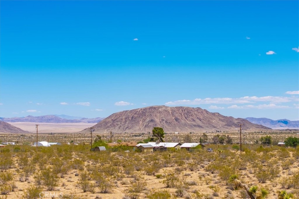 56764 Reche Road Landers, CA 92285 - Photo 1 of 1 a view of a lake with mountains in the background