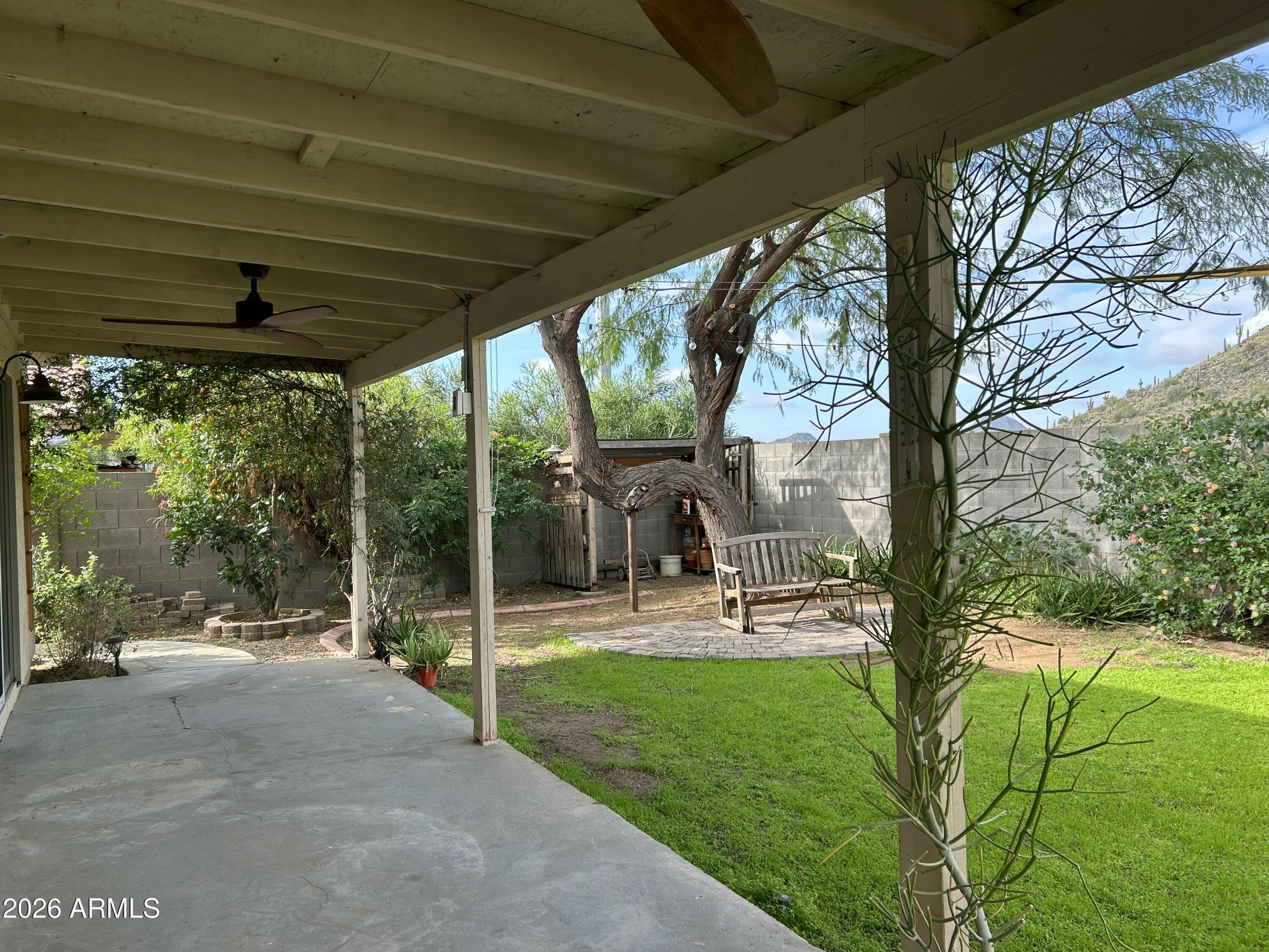 3216 West Mark Lane Phoenix, AZ 85083 - Photo 19 of 23 a view of a porch with chairs and backyard